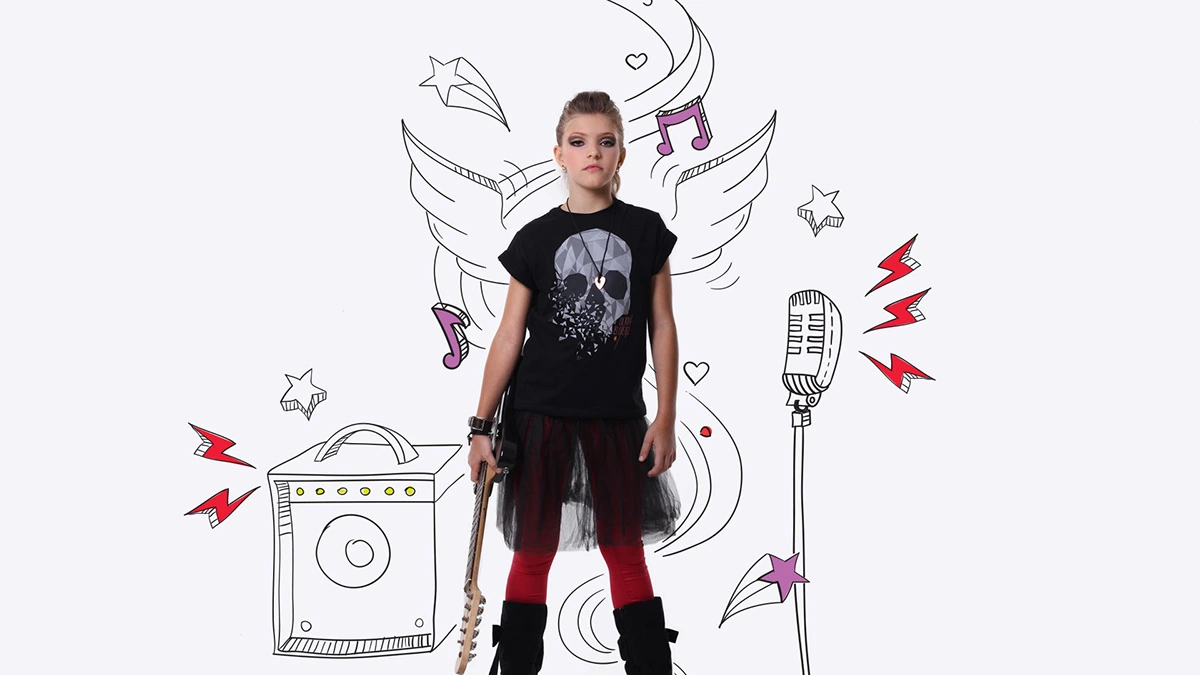Child holding a guitar beside an illustrated microphone, amplifier and wings