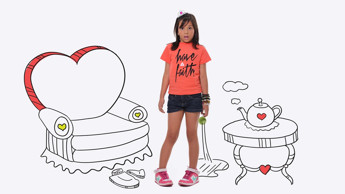 Child beside an illustrated heart-shaped chair and tea table